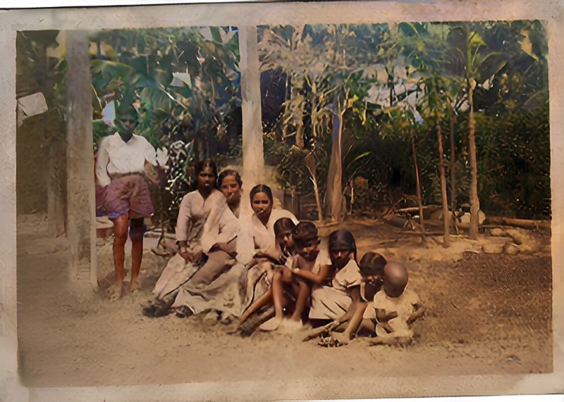 Same family photo restored and colorized with warm natural skin tones and green foliage