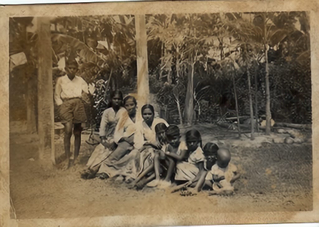 Same family photo restored with cleaner contrast and recovered detail