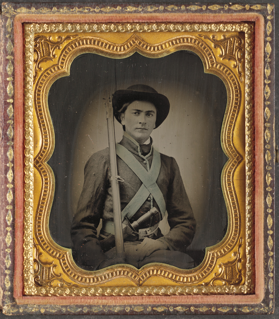 Faded Civil War era ambrotype of a young soldier in ornate case